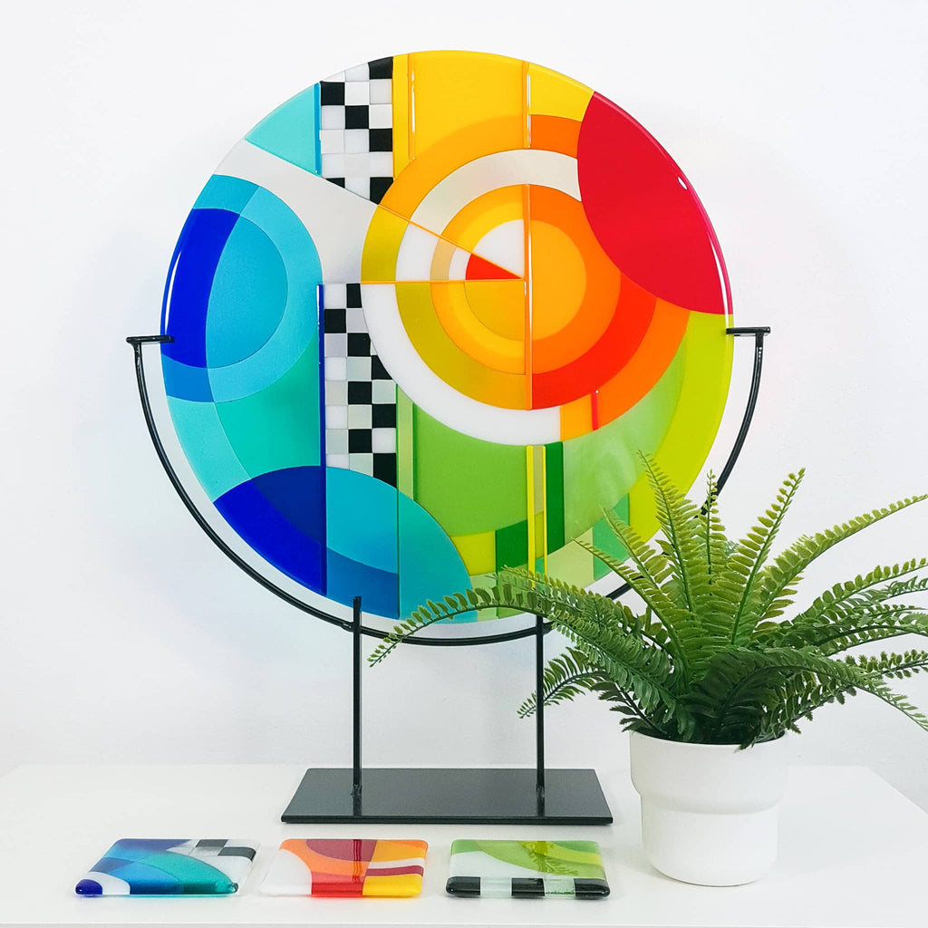 Chequer large round fused glass art sculpture by Glass Art by Linda. Fused glass artwork in rainbow colours in a Hard Edge glass art style