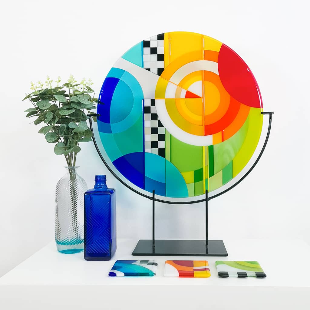 Unique glass roundel in rainbow colours in a Hard Edge glass art style