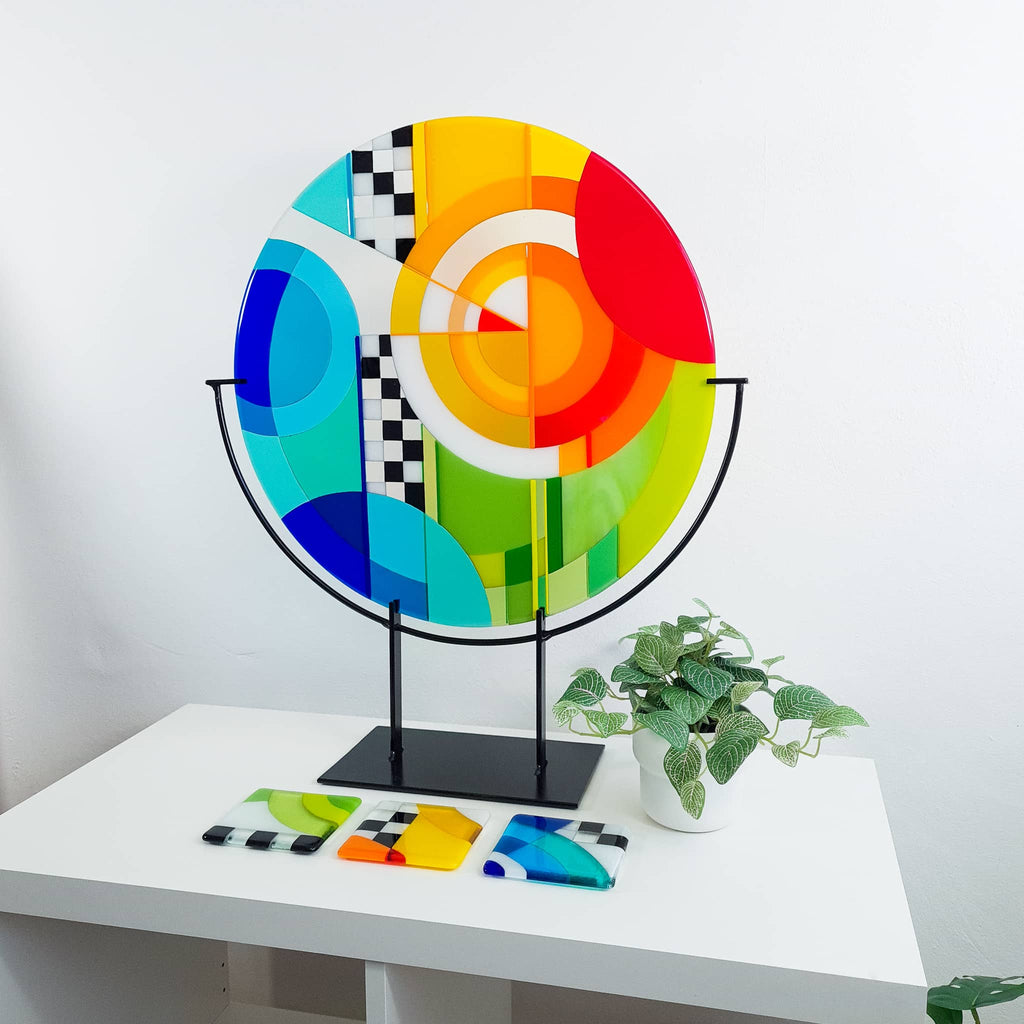 Chequer large round fused glass art sculpture. Unique glass roundel in rainbow colours in a Hard Edge glass art style