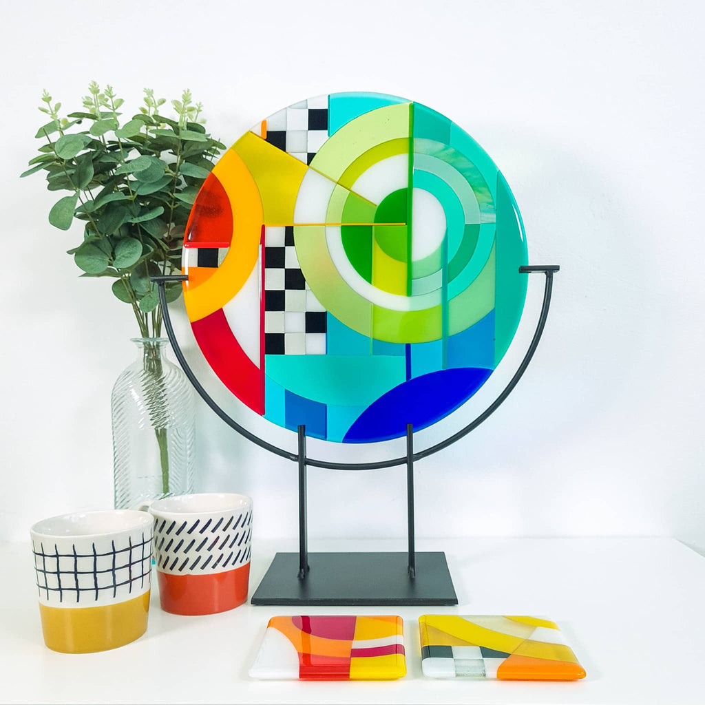 Chequer medium round fused glass art sculpture by Glass Art by Linda. Fused glass roundel in rainbow colours in a Hard Edge glass art style