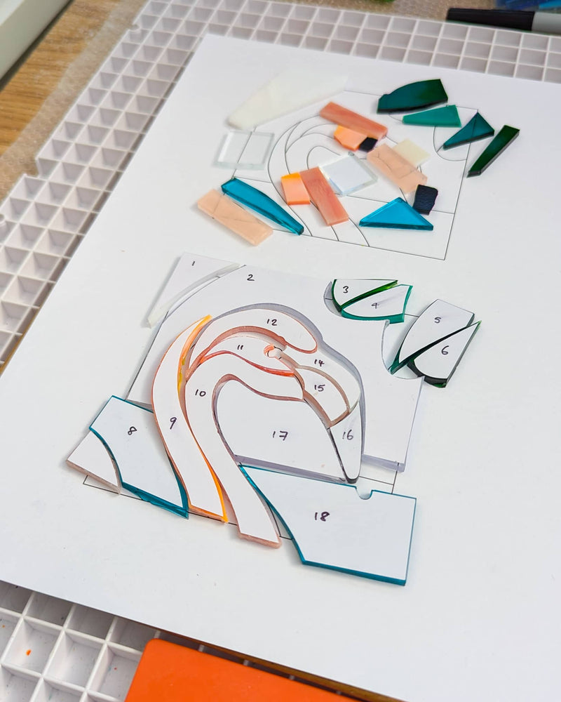 Work in progress on the commissioned Flamingo Miniature showing individually cut glass pieces before assembly