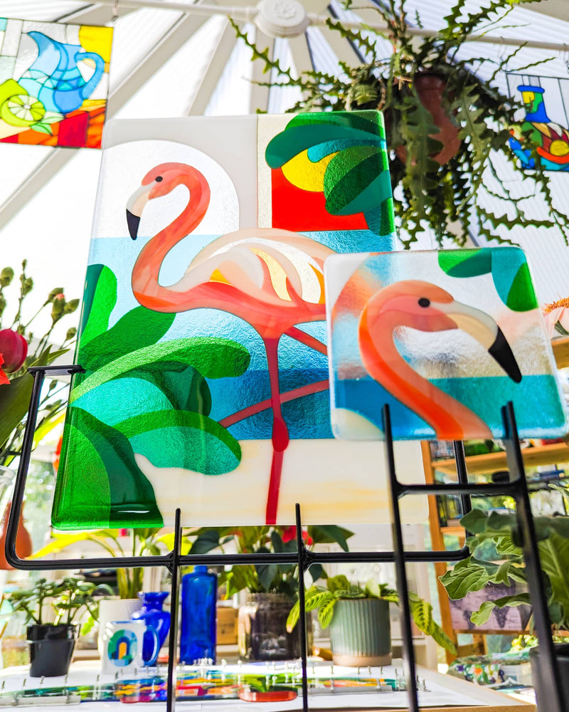 Commissioned Flamingo Miniature displayed alongside the larger 'Flamboyance' contemporary glass artwork by Linda Rossiter