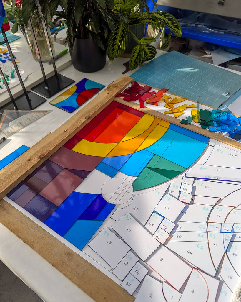 Cutting stained glass pieces to create a fused glass window panel