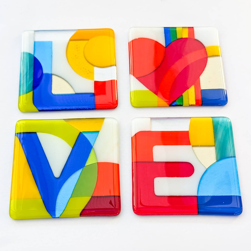 Fused glass art alphabet coasters spelling "LOVE"