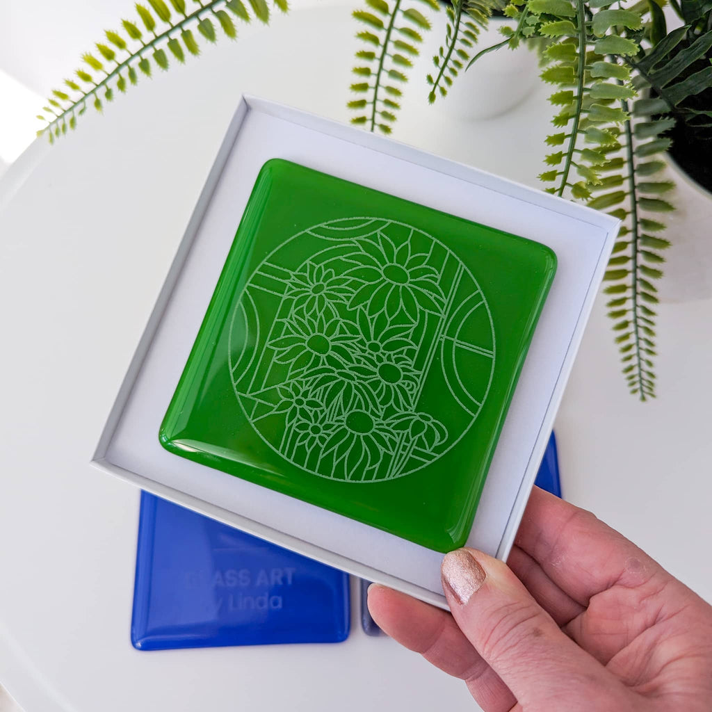 Fused glass coaster with engraved design