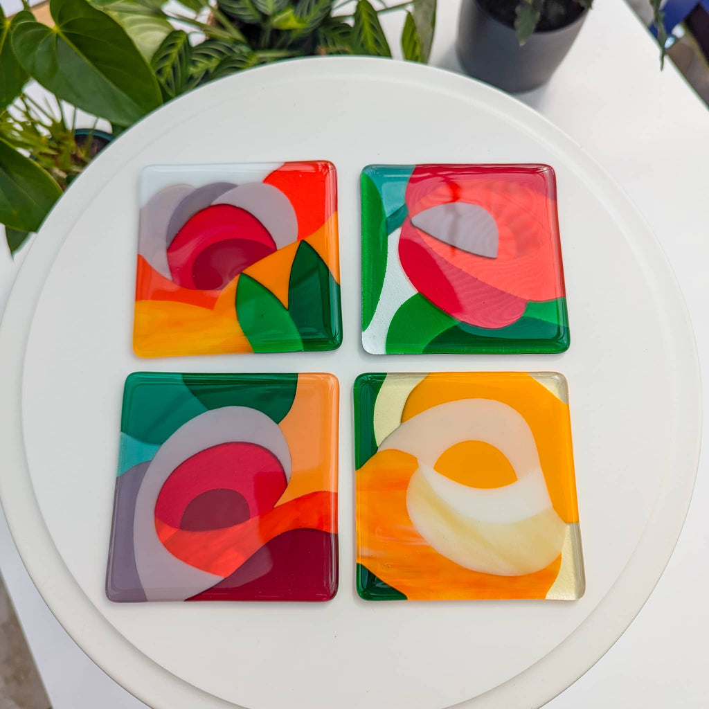 A set of 4 fused art glass Miniatures in a floral theme