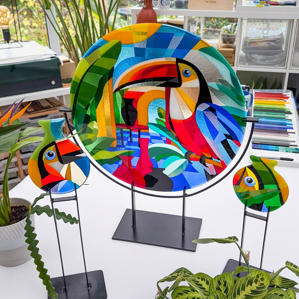 Toucans: Fused glass art roundel in the Hard Edge glass art style. Complete with 2 fused glass art miniatures on steel stands