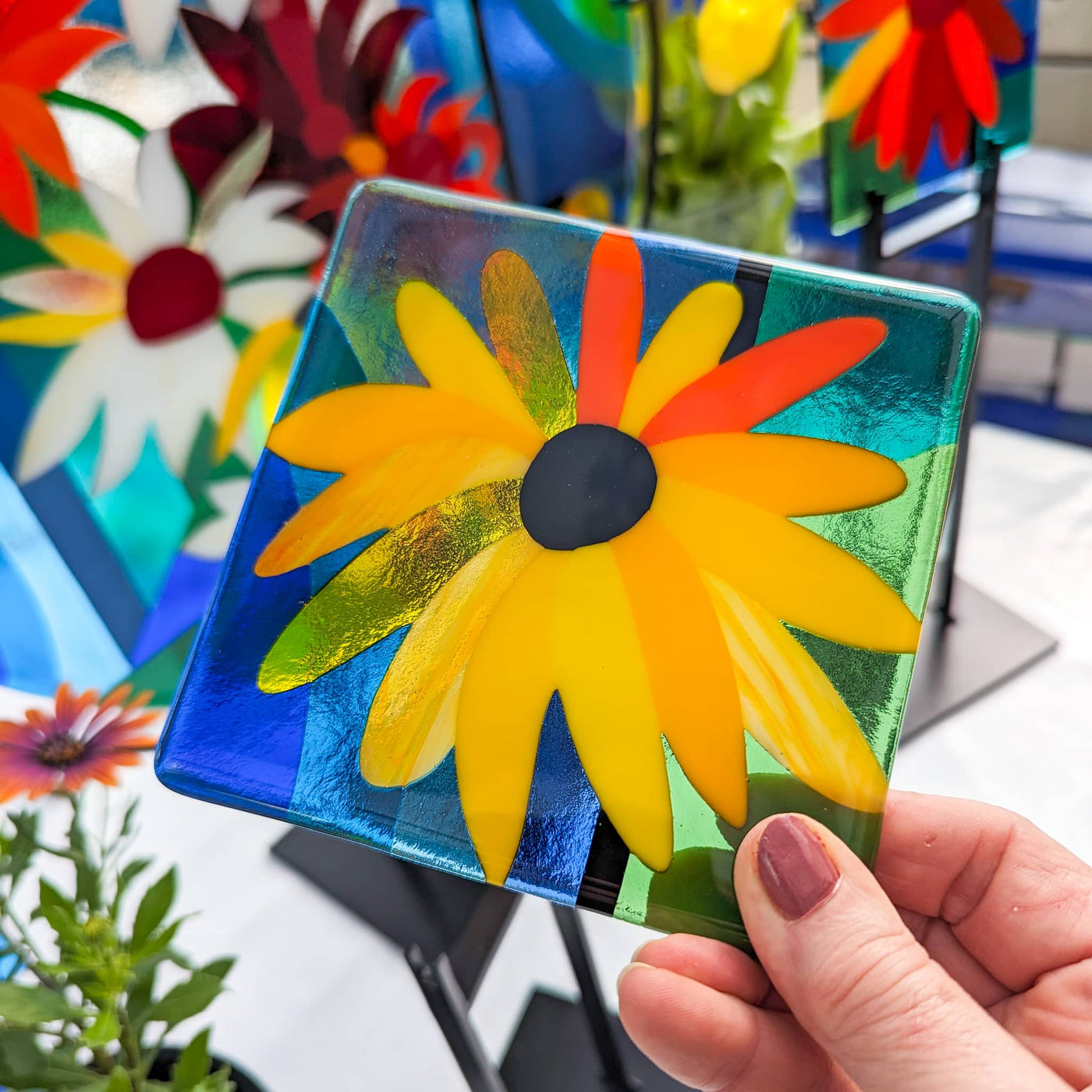 Close-up of one of the 'Abundance' contemporary Hard Edge glass floral miniatures, showing bold flower shapes, vibrant colours and geometric forms inspired by the larger artwork