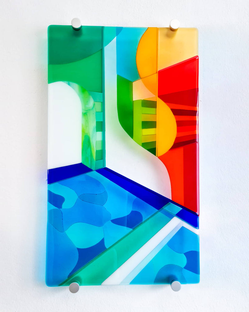 Left panel of the Biarritz diptych with blue water, a white arch and abstract green, yellow and red architecture