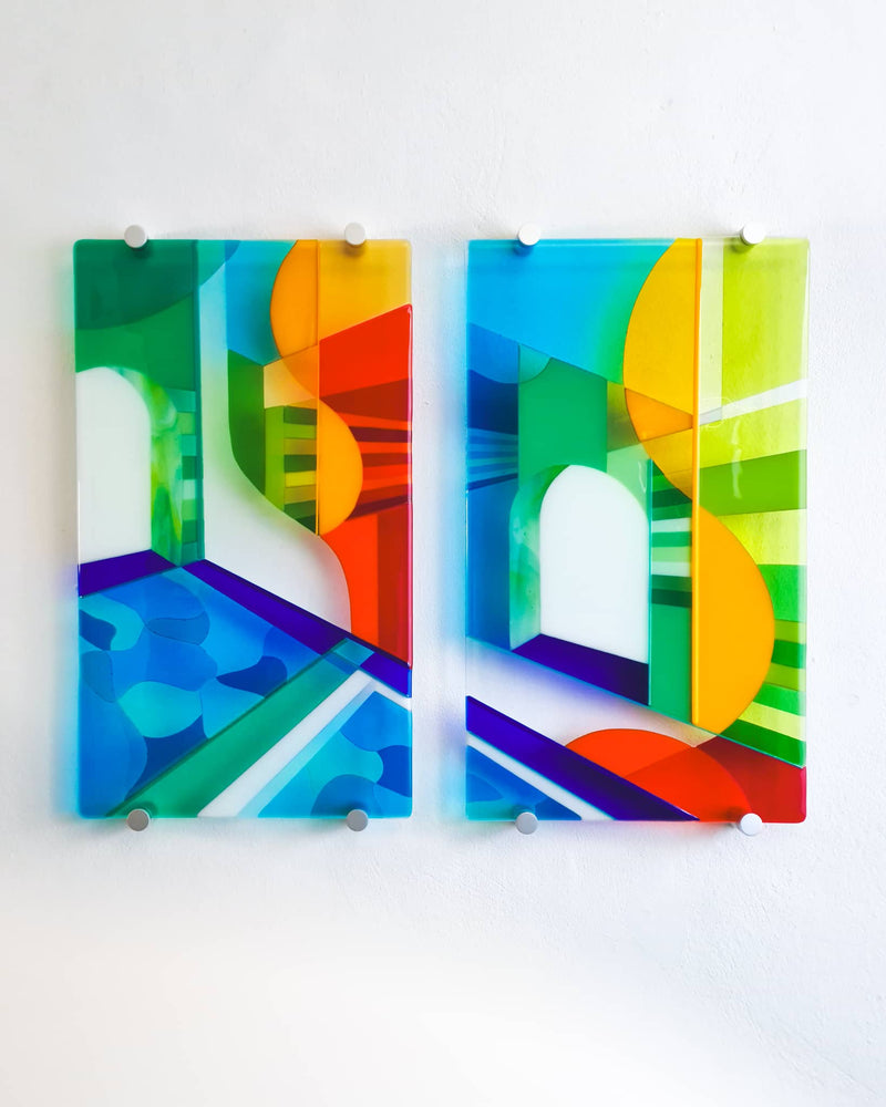 Biarritz contemporary fused glass diptych with two vertical panels combining blue water and colourful abstract architectural shapes