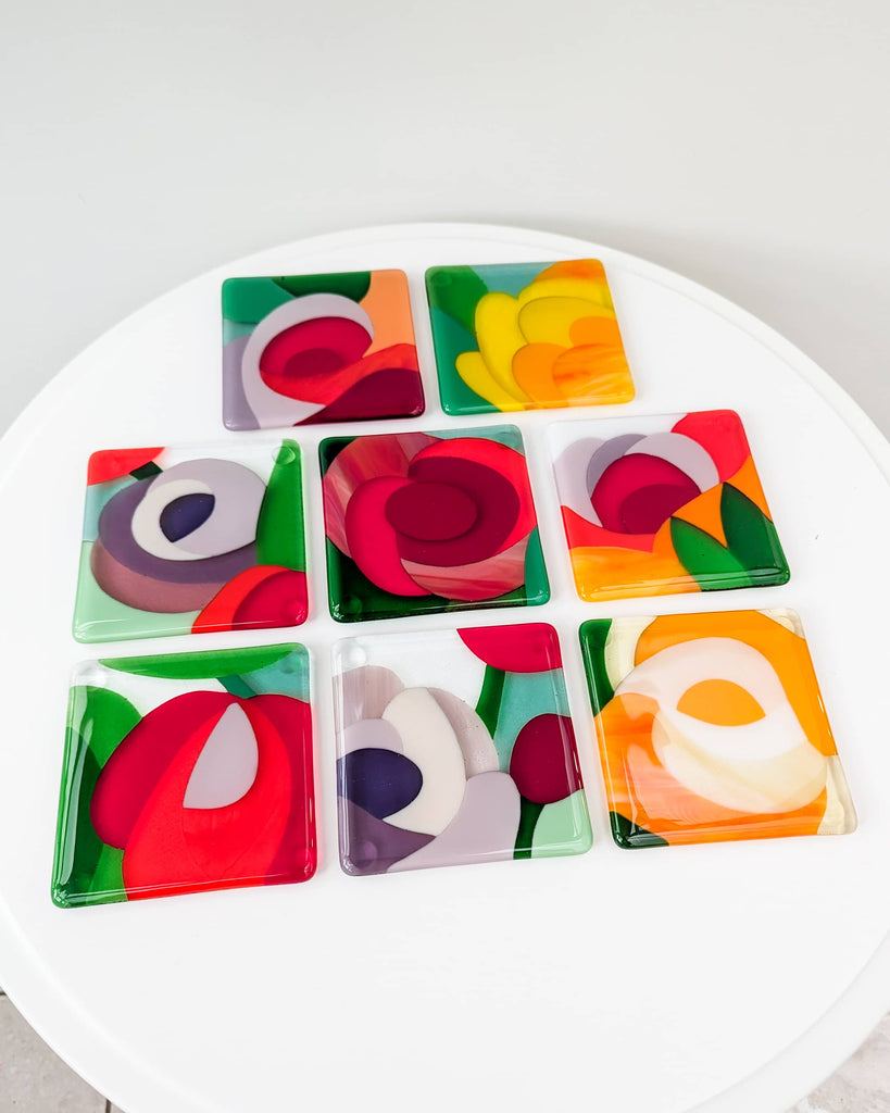 Set of four floral-themed fused glass miniatures