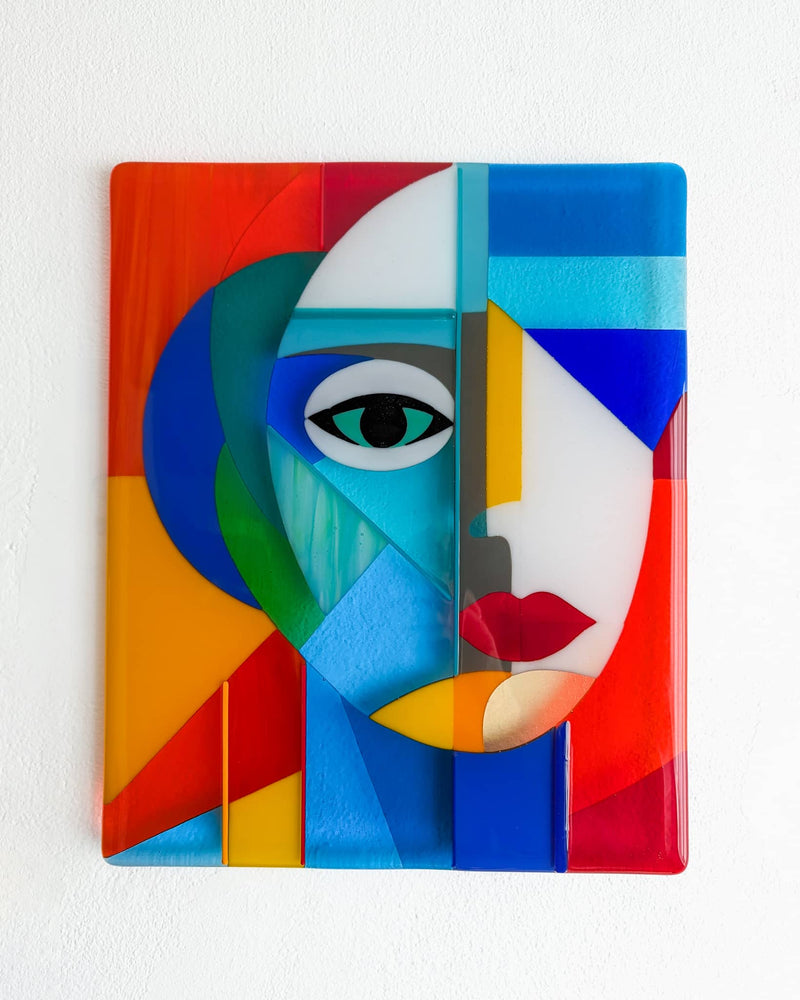 Colourful abstract female face in fused glass, forming the central panel of Gallery
