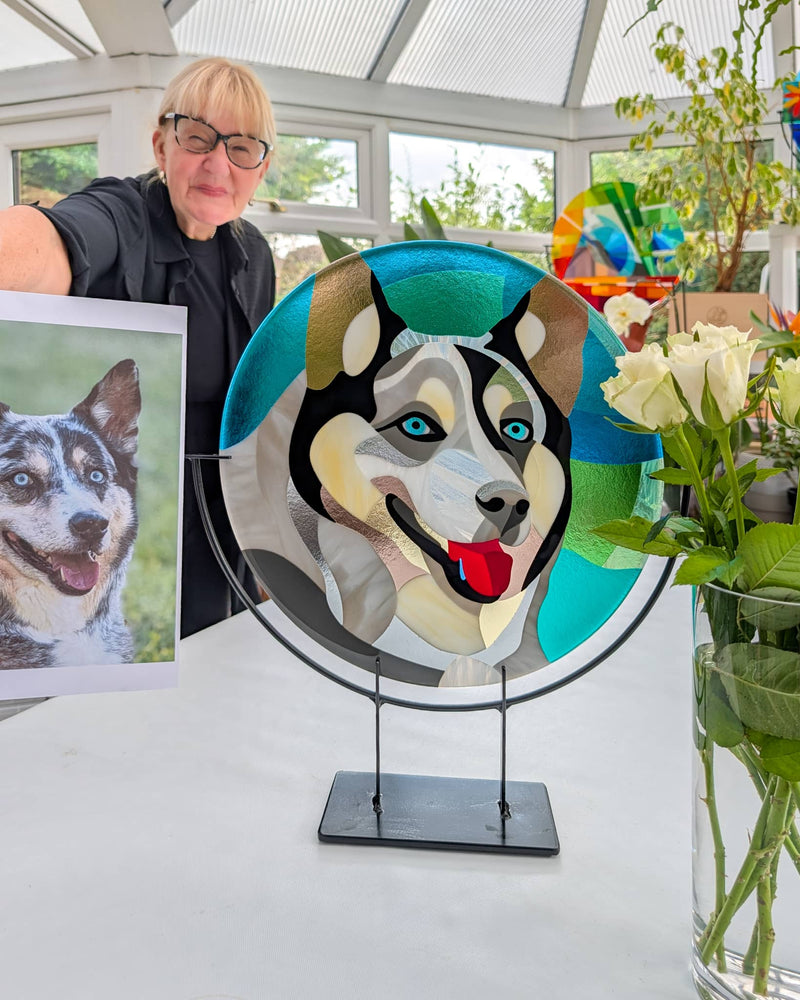 Linda Rossiter with the completed Hard Edge glass portrait of Blue and one of the photographs used as reference