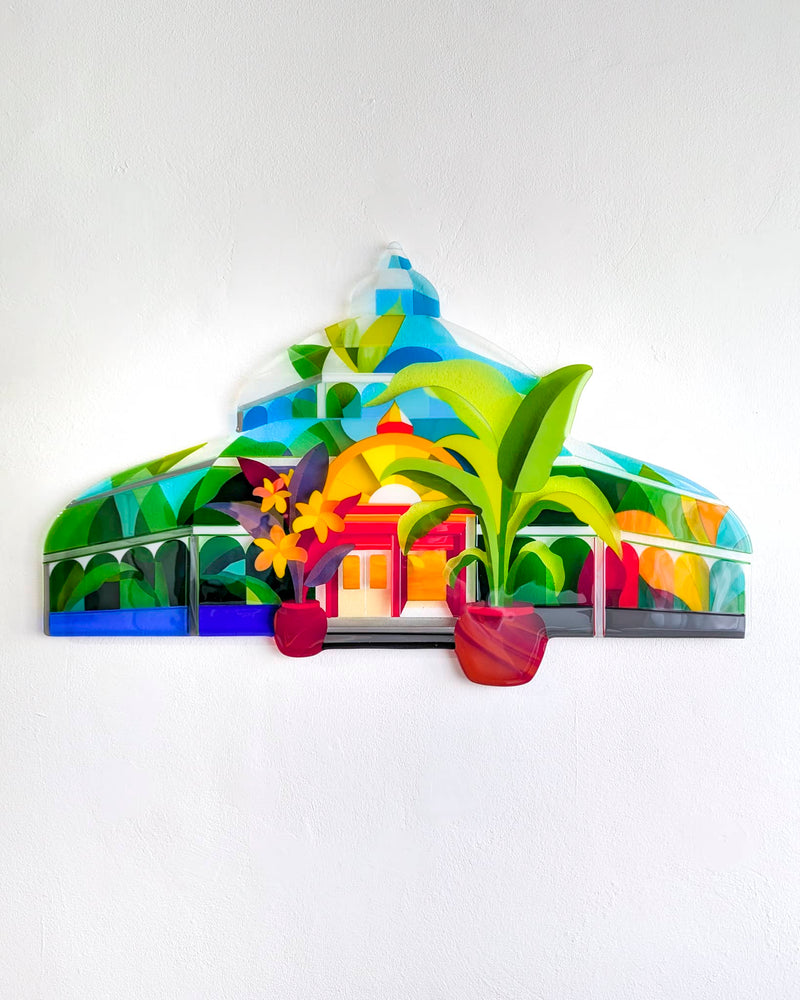 Colourful fused glass wall artwork shaped like a Victorian palm house, with tropical plants and red pots