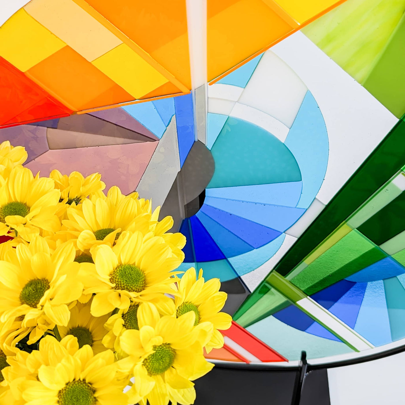 Close-up of 'Stairs' contemporary Hard Edge glass roundel showing the sweeping geometric forms, coloured glass and fine glass stringers