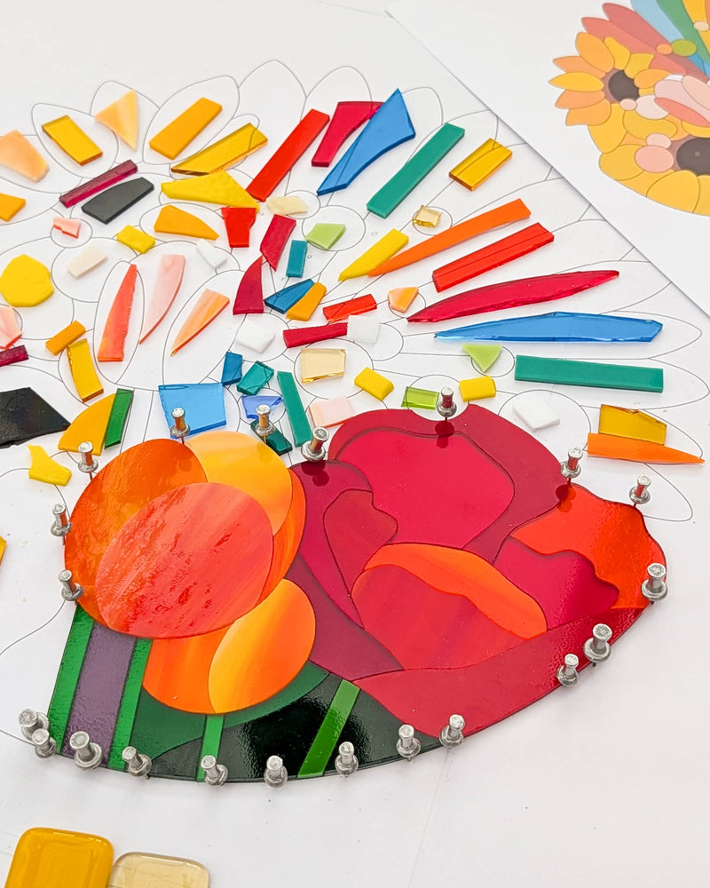 Individually cut pieces of colourful glass being fitted together for the Sunshine wedding anniversary commission