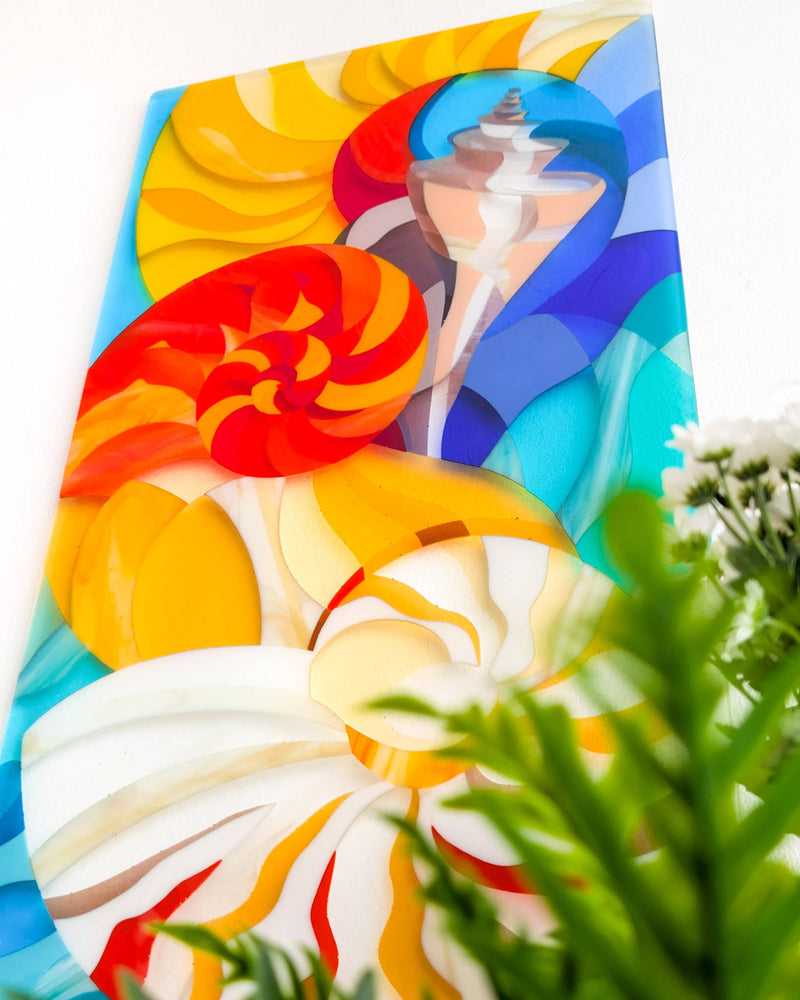 Close-up of the commissioned contemporary Hard Edge glass seashell artwork showing swirling shell forms and flowing colour created from individually cut glass pieces