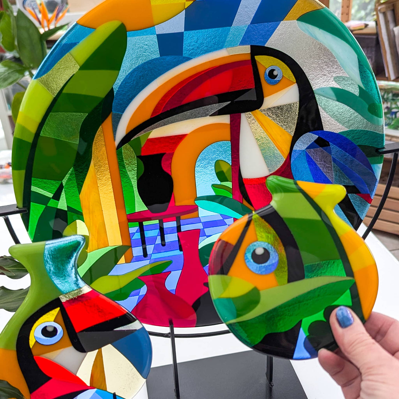 'Toucans' commissioned contemporary Hard Edge glass roundel with two matching toucan miniatures on steel stands, inspired by the colourful tropical birds