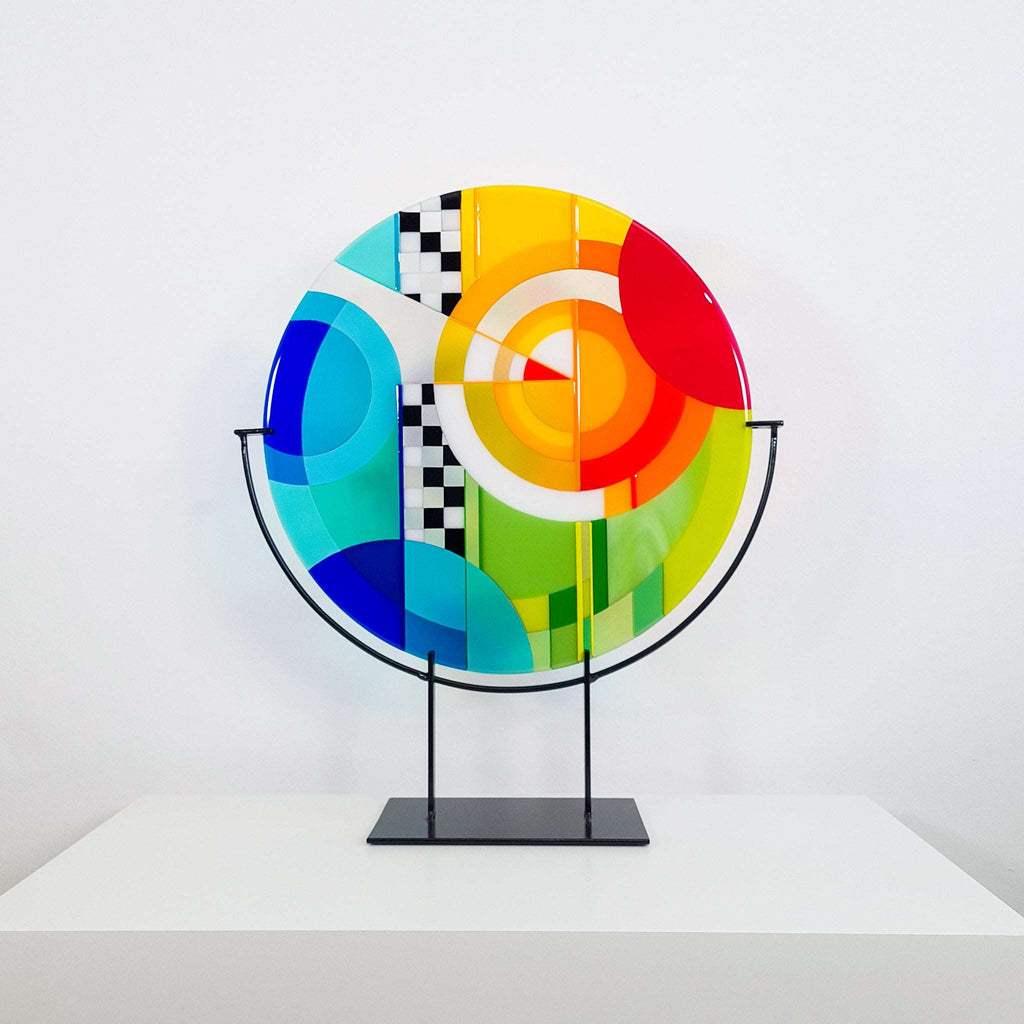 Chequer large round fused glass art. Fused glass artwork in rainbow colours in a Hard Edge glass art style
