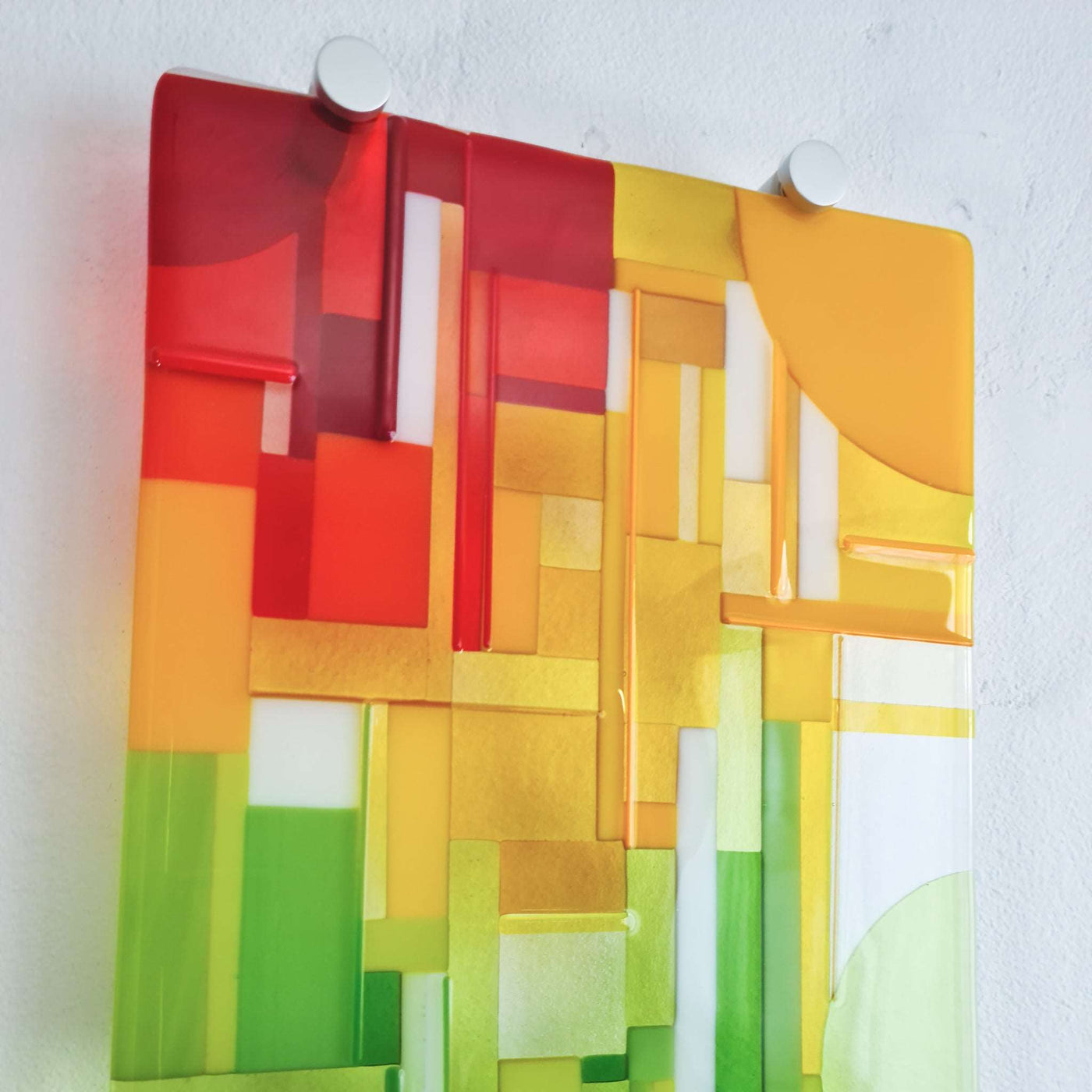 Close-up of 'Spectrum' contemporary Hard Edge glass wall artwork showing the red, orange and yellow section with geometric forms and fine glass noodles